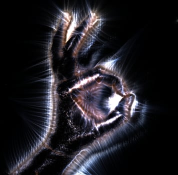 3D-Illustration of a glowing human female hand with a kirlian aura showing different symbols photo