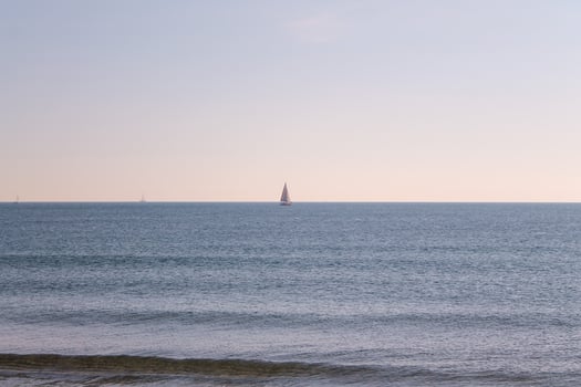 View of the sea with sails on the horizon photo
