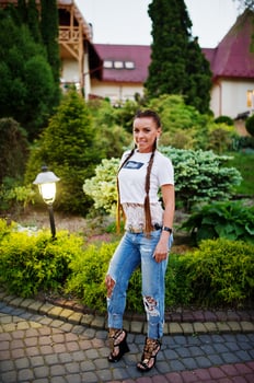 Fabulous bridesmaid wearing jeans and white t-shirt posing outside at bachelorette party. photo