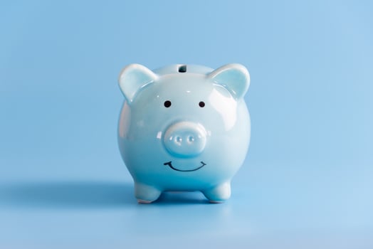 Blue piggy bank isolated on light blue background photo