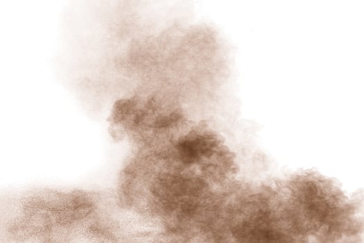 Brown powder dust cloud.Brown particles splattered on white background. photo