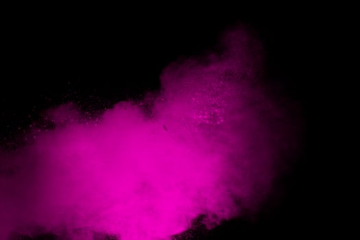 Pink powder explosion isolated on black background. photo
