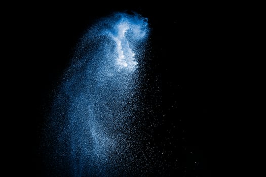 Blue color powder explosion on white background. photo