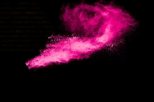 Pink powder explosion on black background. photo