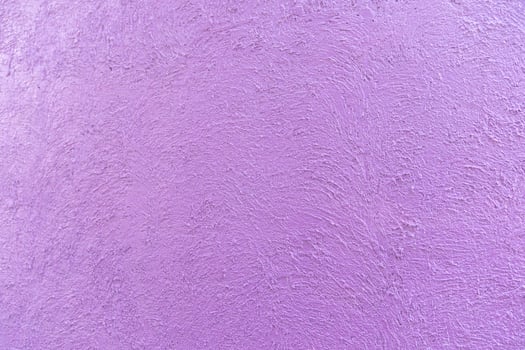 purple - violet colour on the abstract random texture curve cement on the wall at afternoon time. photo