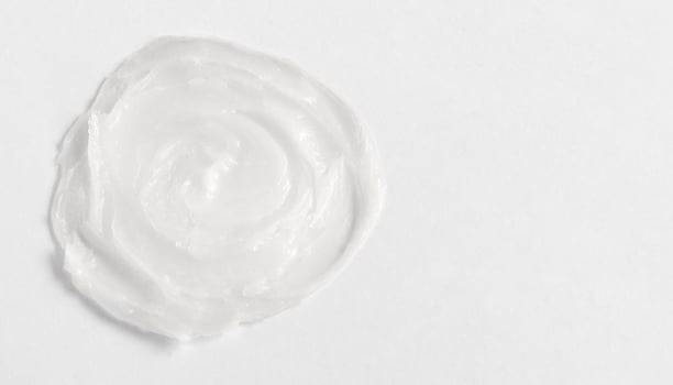 The texture of the lip balm. Transparent ointment on a white background and copy space photo