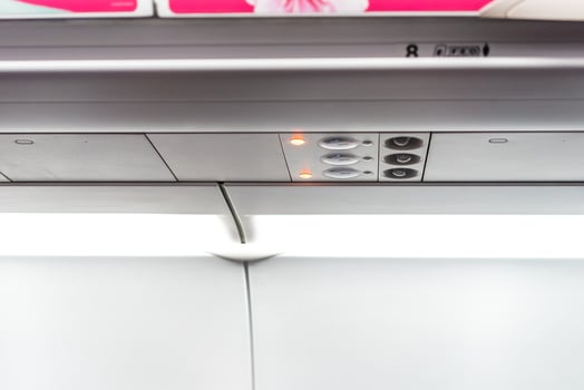 closeup airplane Console panel lamp, light, need help button, air condition, sefty belt and no smoking lighting sign. photo