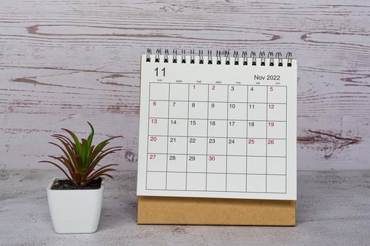 White November 2022 calendar on wooden desk. 2022 new year concept. photo