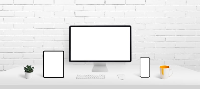 Responsive devices display mockup on work desk. Computer display, smart phone and tablet on work desk with isolated screen for app or web page presentation photo