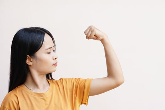 Asian women pushing their muscles to show off their strength. photo