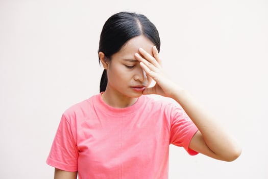 Asian women suffer from work stress. Put your hand on your head photo
