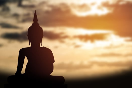 Silhouette of Buddha. Background sunrise photo