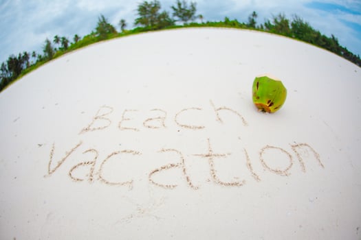 Holidays summer concept. The word beach vacation written in the sand photo