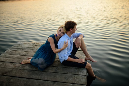 Man and woman on the pier near the lake. photo