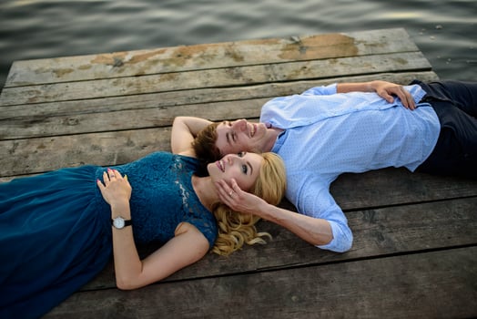 Man and woman on the pier near the lake. photo