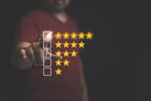 Customer review feedback survey, satisfaction ranking high. A man give rating to service experience on online application. Customer can evaluate of service leading to reputation ranking of business. photo