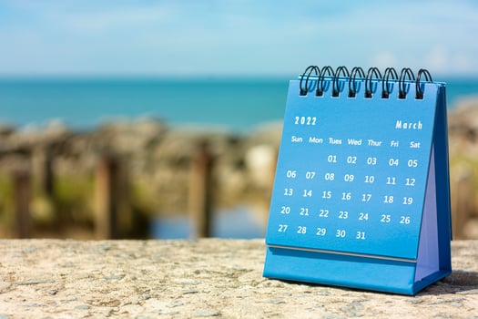 Blue March 2022 calendar on blurred background of blue ocean photo
