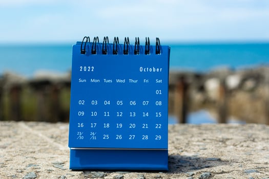 Blue October 2022 calendar on blurred background of blue ocean photo
