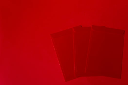 Red packets on red background - Chinese New Year Concept photo