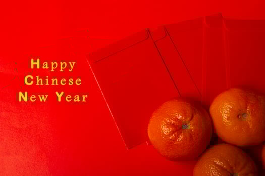 Chinese New Year Concept - Mandarin oranges and red packet photo