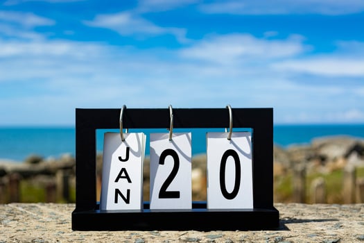 Jan 20 calendar date text on wooden frame with blurred background of ocean photo