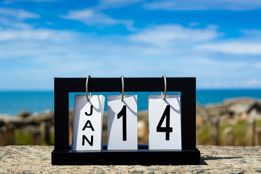 Jan 14 calendar date text on wooden frame with blurred background of ocean photo