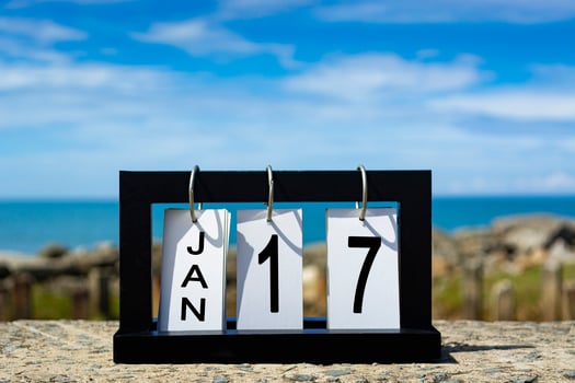 Jan 17 calendar date text on wooden frame with blurred background of ocean photo