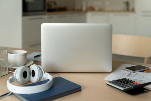 Freelance desk with laptop in kitchen room. Work from home. Distance education. photo