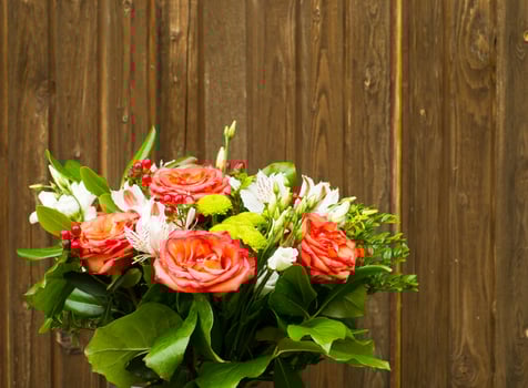 bouquet of flowers on a old wooden background with copy space photo