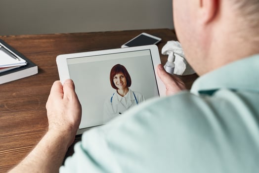 Man looks at tablet, video call to doctor, communication with doctor online. Telemedicine photo
