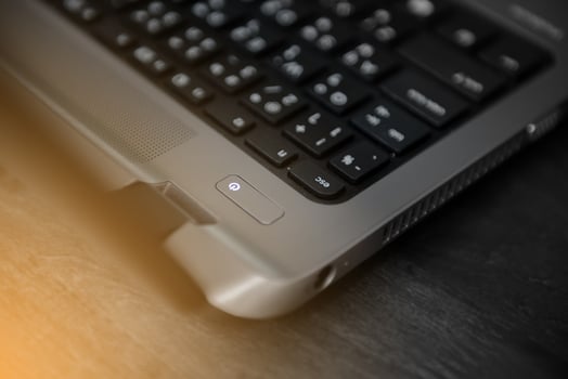 Close up to power button on laptop photo
