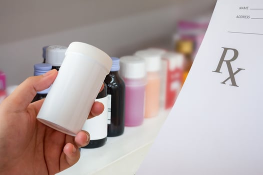 female pharmacist with prescription and medicine bottle at the pharmacy photo