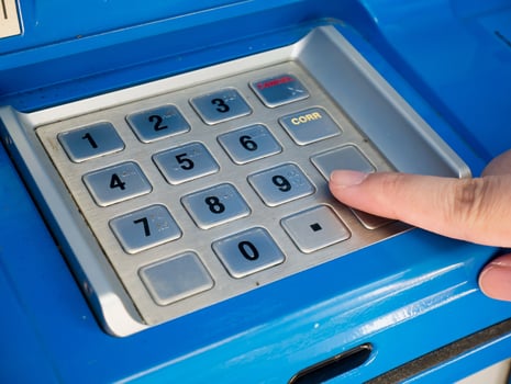 woman using ATM machine to withdraw money photo