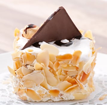 Gentle almond cake with whipped cream and chocolate photo
