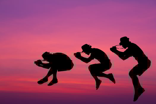 Silhouette photographer jumped in the sky. photo