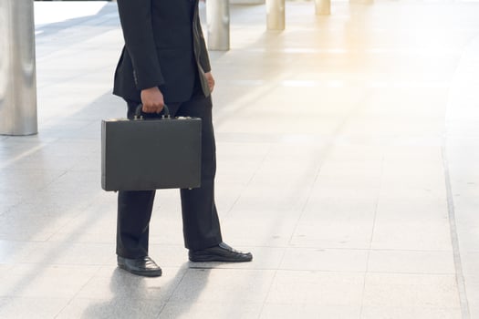 Businessman pulling a bag in a big city. photo