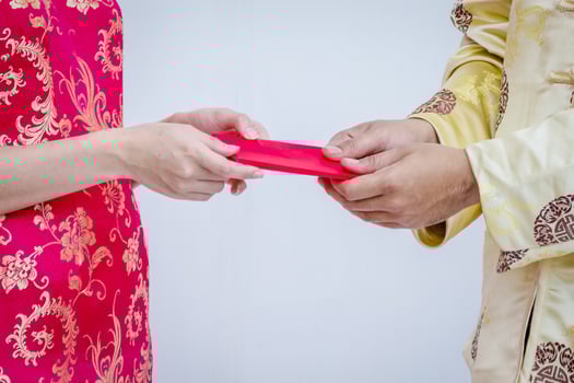 Asian couple holding red Chinese new years envelopes. Chinese new year. photo