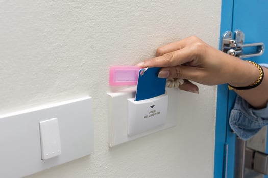 Asian women hand hold card for door access control scanning key card to lock and unlock door. photo
