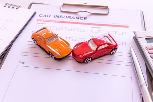 Car insurance form with model and policy document photo