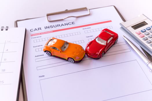 Car insurance form with model and policy document photo