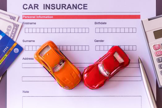 Car insurance form with model and policy document photo