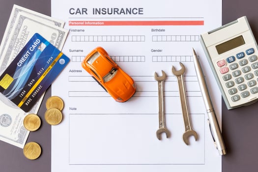 Car insurance form with model and policy document photo
