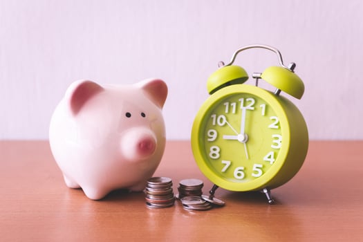 Piggy bank, alarm clock and coins. for growing business. time to saving concept. photo