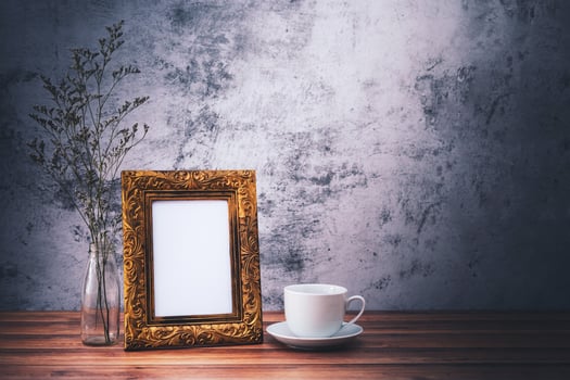 Picture frame and flowers and Coffee mugs on wooden table. Poster product design styled photo