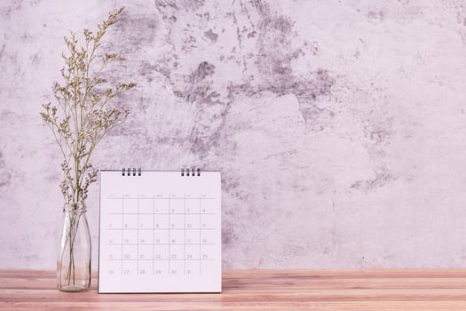 calendar and caspia flower on table wooden. Day celebration photo