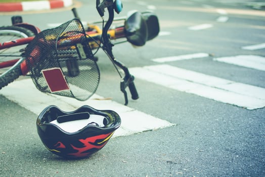 Helmet and bike lying on the road on a pedestrian crossing, after accident photo
