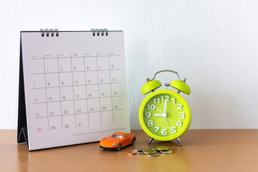 Calendar and car on table. Day of buying or selling a car or payment for rent or loan or repair photo