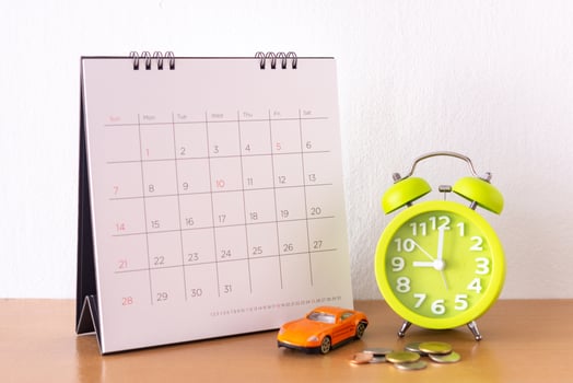 Calendar and car on table. Day of buying or selling a car or payment for rent or loan or repair photo