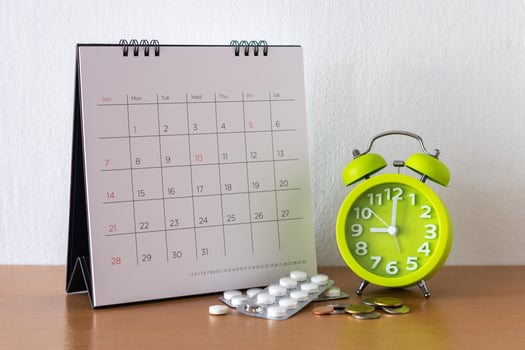 Calendar and drugs on table. photo