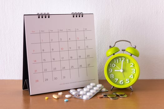 Calendar and drugs on table. photo
